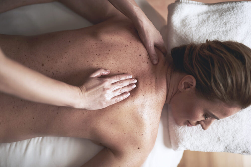 Top View Of Young Lady Having Massage In Spa Salon